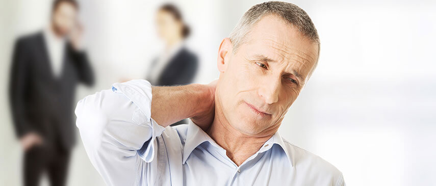 A man experiencing neck pain in a business setting.