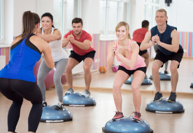 Group of people participating in a fitness class with balance trainers to achieve an Active Lifestyle.