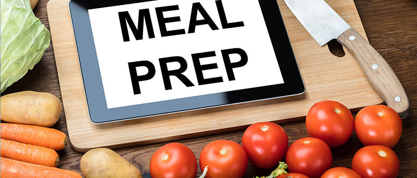 Tablet with "Core Exercises" text surrounded by fresh vegetables and a cutting board.