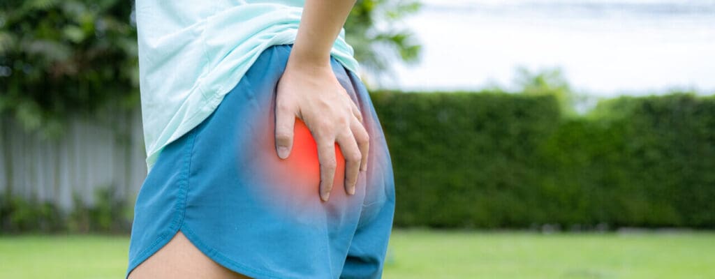 Person experiencing hip pain, highlighted by a red overlay, potentially benefiting from Physical Therapy.