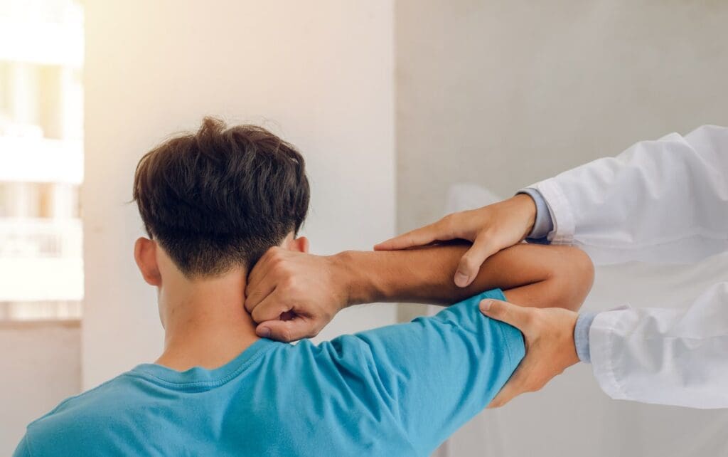 Chiropractor performing a neck adjustment to alleviate pain for a male patient.